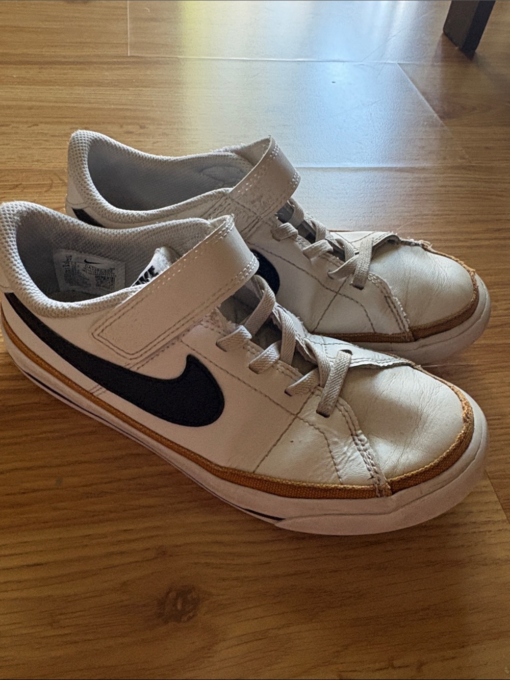 Nike White and Black Kids Sneakers with Gold Trim